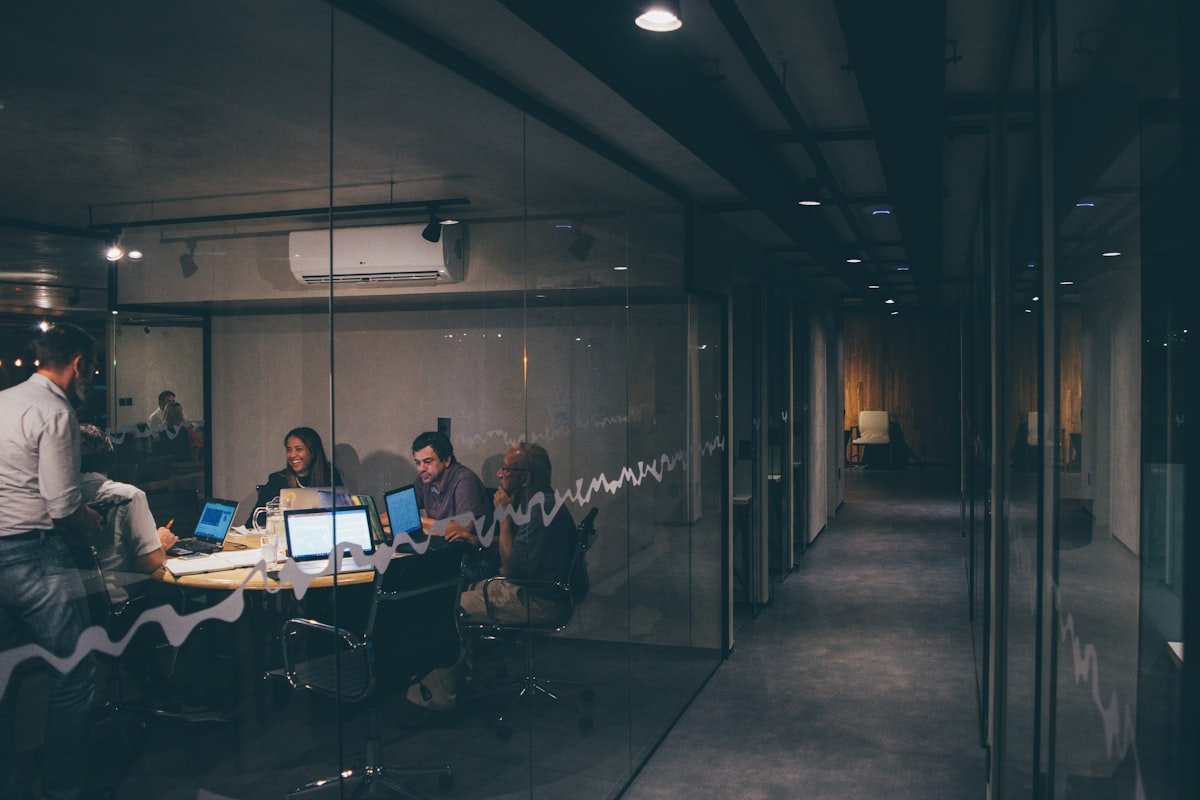 Group of startup founders and investors gathered around a table in a meeting